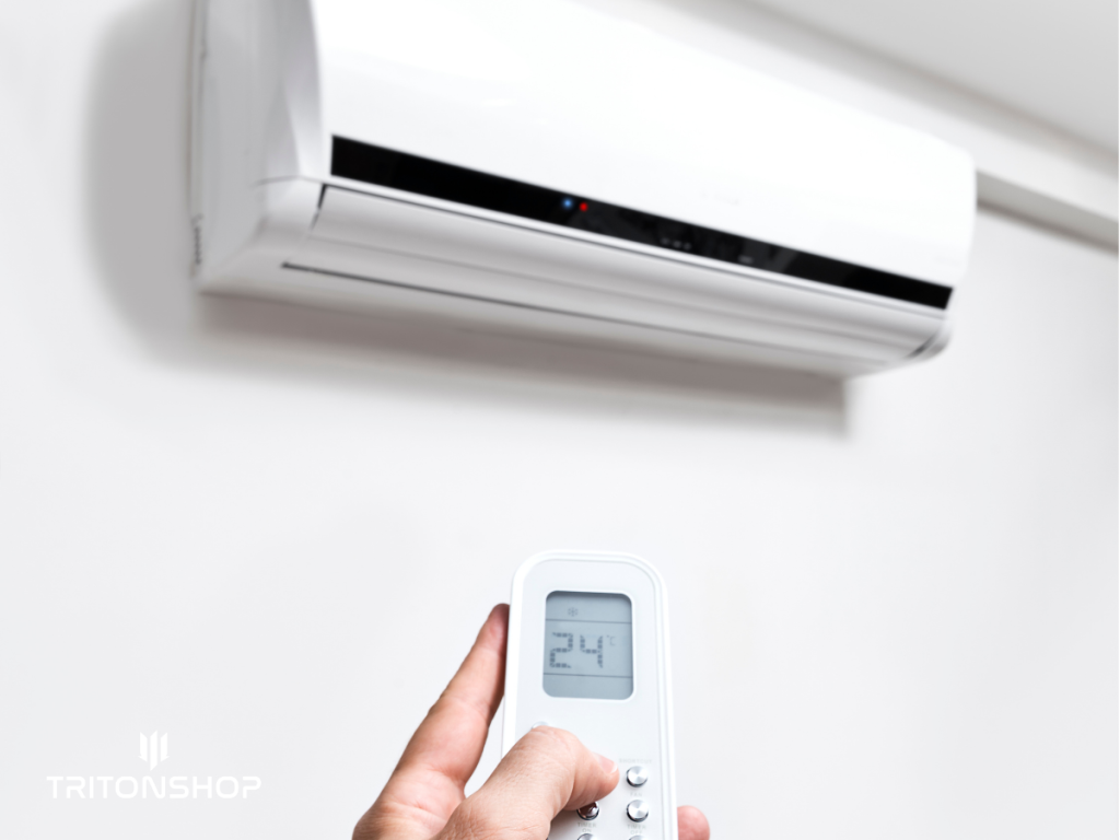 Egy férfi éppen 24 celsius fokra állítja be a klímát a hideg téli időben.